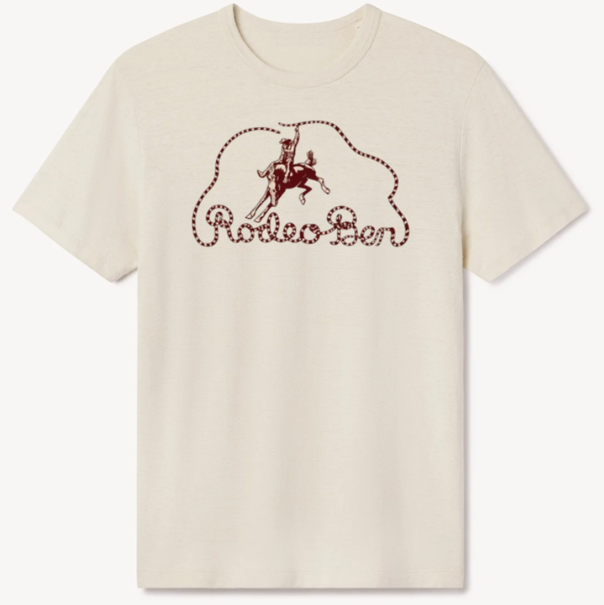 An off-white short-sleeve crewneck t-shirt featuring a dark red graphic on the chest with a cowboy on a horse inside a lasso outline and the text 'Rodeo Ben'.